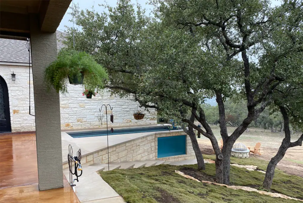 Ecopool with stone landscaping and acrylic window
