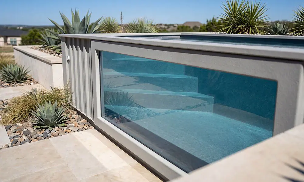 Clean acrylic pool window on grey Ecopool container