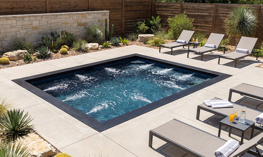 Large inground Ecopool spa with stone coping