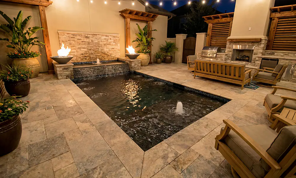 Inground pool with LED lighting at night showcasing dark interior finish